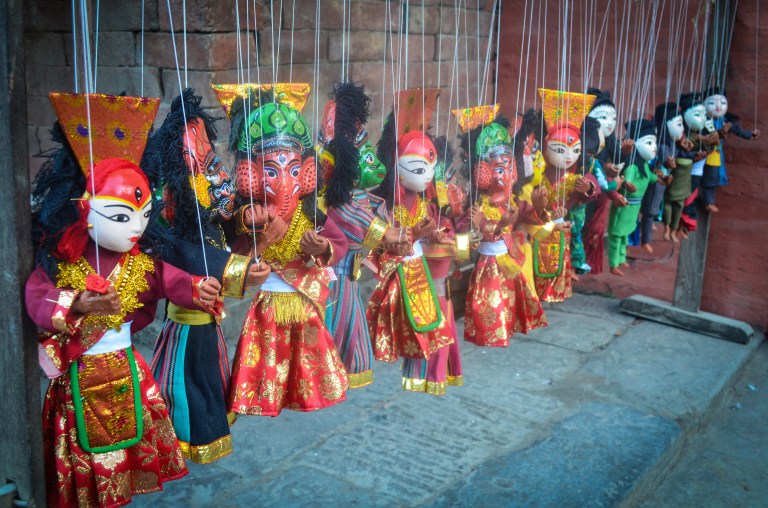 Handmade dolls watching over the scene in Durbar Square.